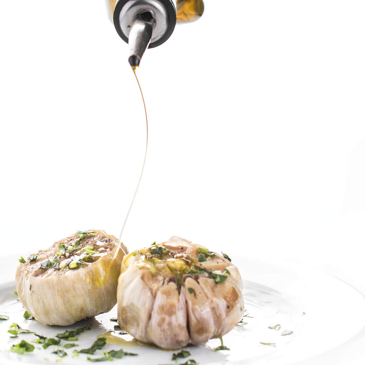 Drizzling Olive Oil on garlic