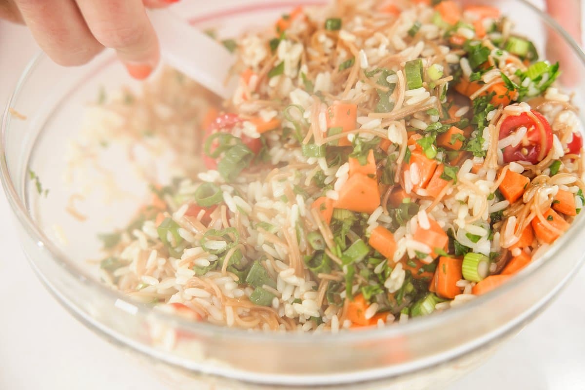 mixing lebanese rice salad in a bowl