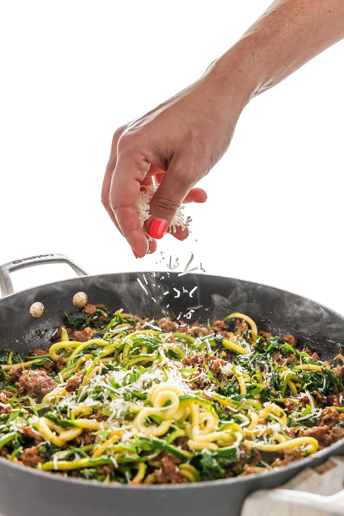 sprinkling parmesan cheese in pan