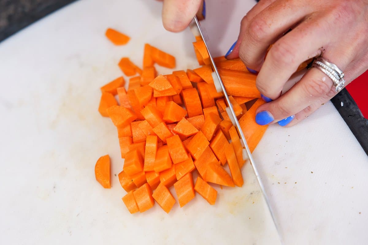 person cutting carrots