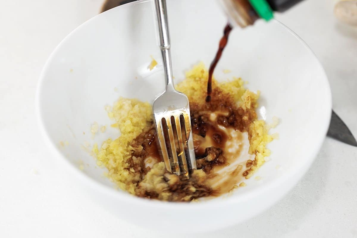 Adding soy sauce to bowl