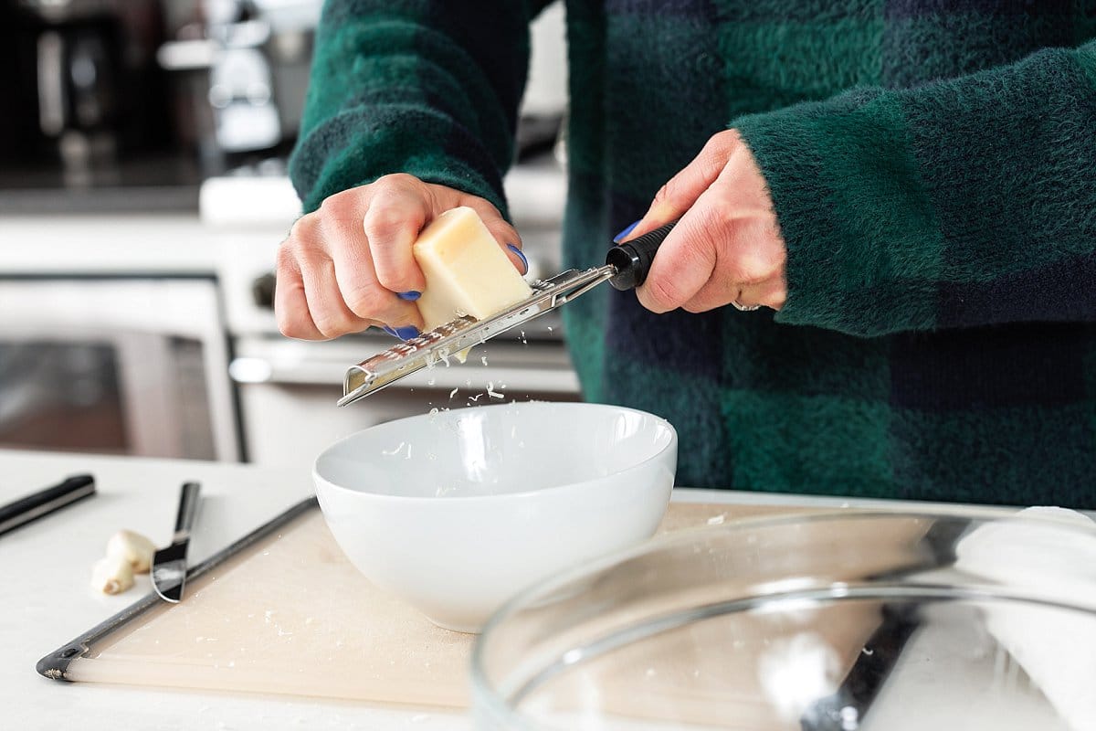 Freshly grating parmesan cheese