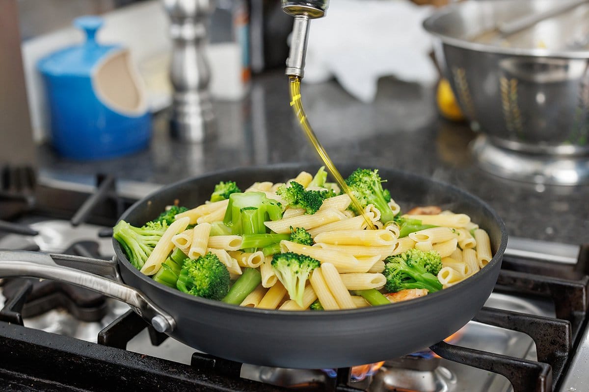 Drizzling pasta with olive oil