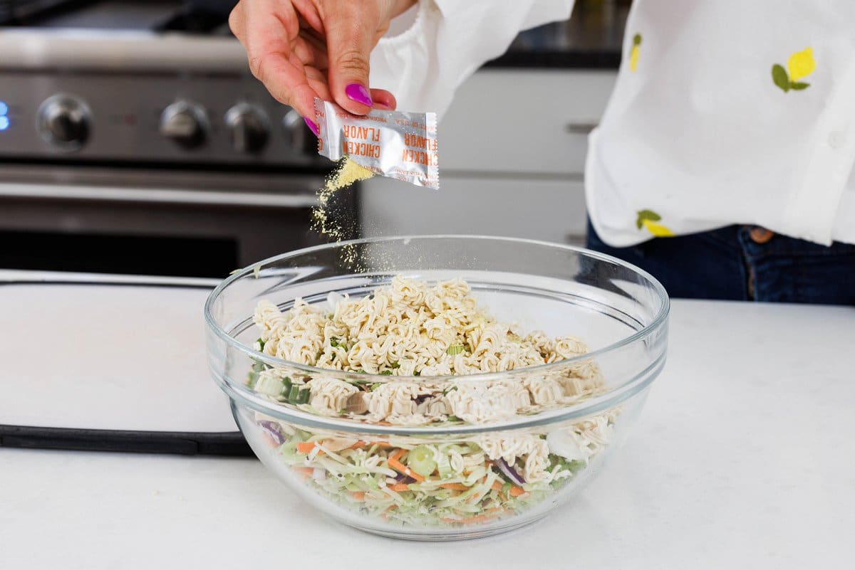 Sprinkling chicken flavor over slaw