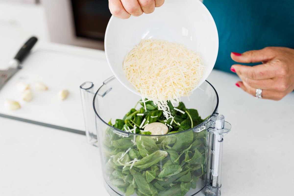 Adding parmesan cheese to food processor