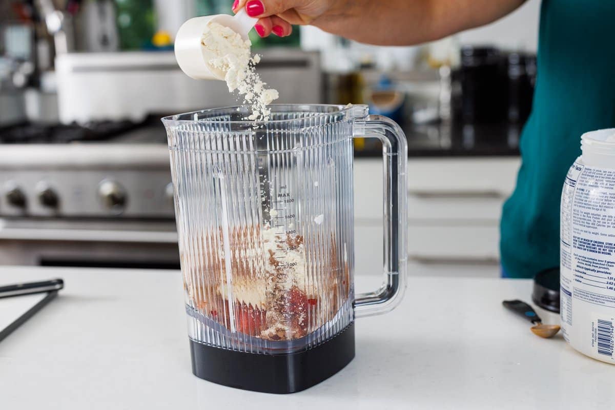 Adding protein powder to blender