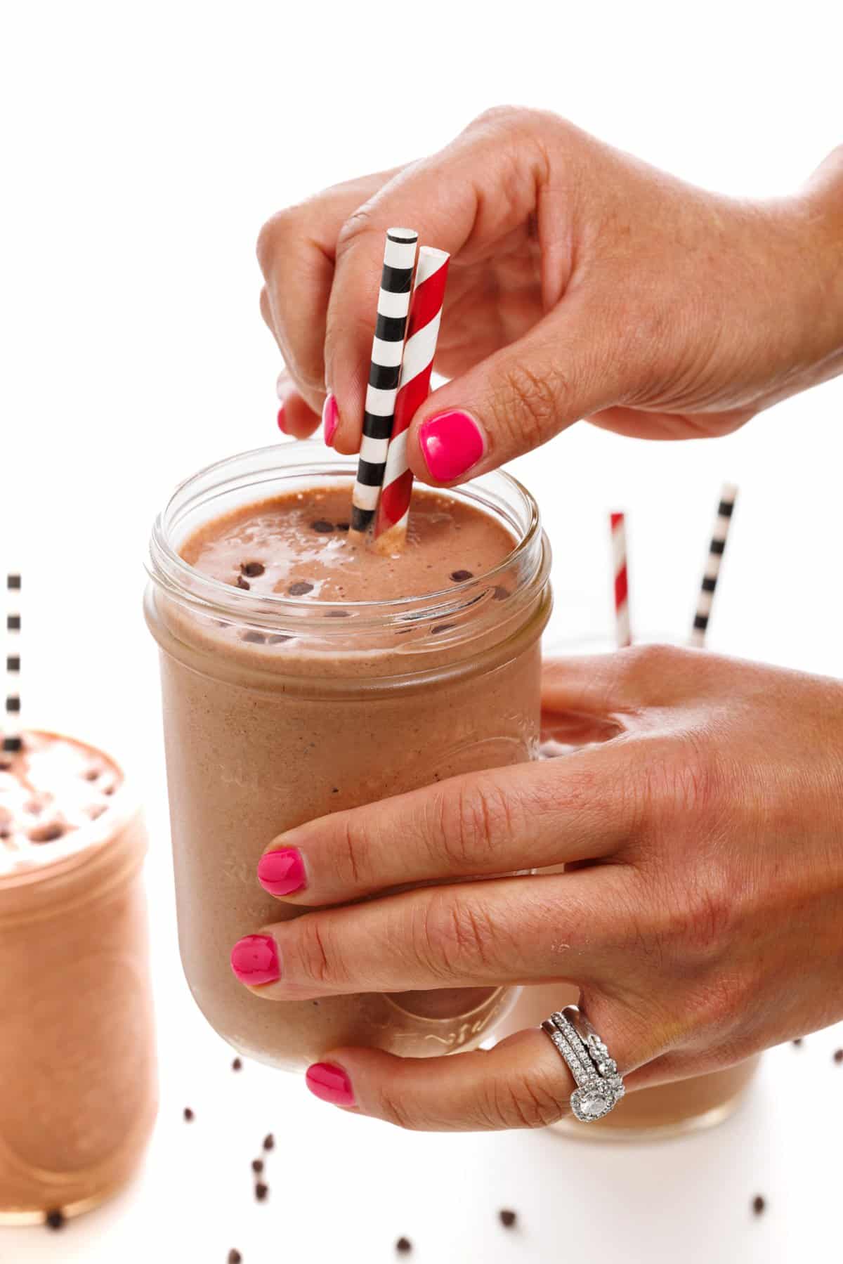 Banana, strawberry and chocolate milkshake in plastic cup with