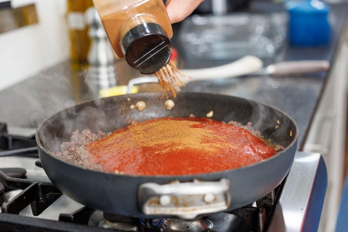 Adding cinnamon to pot