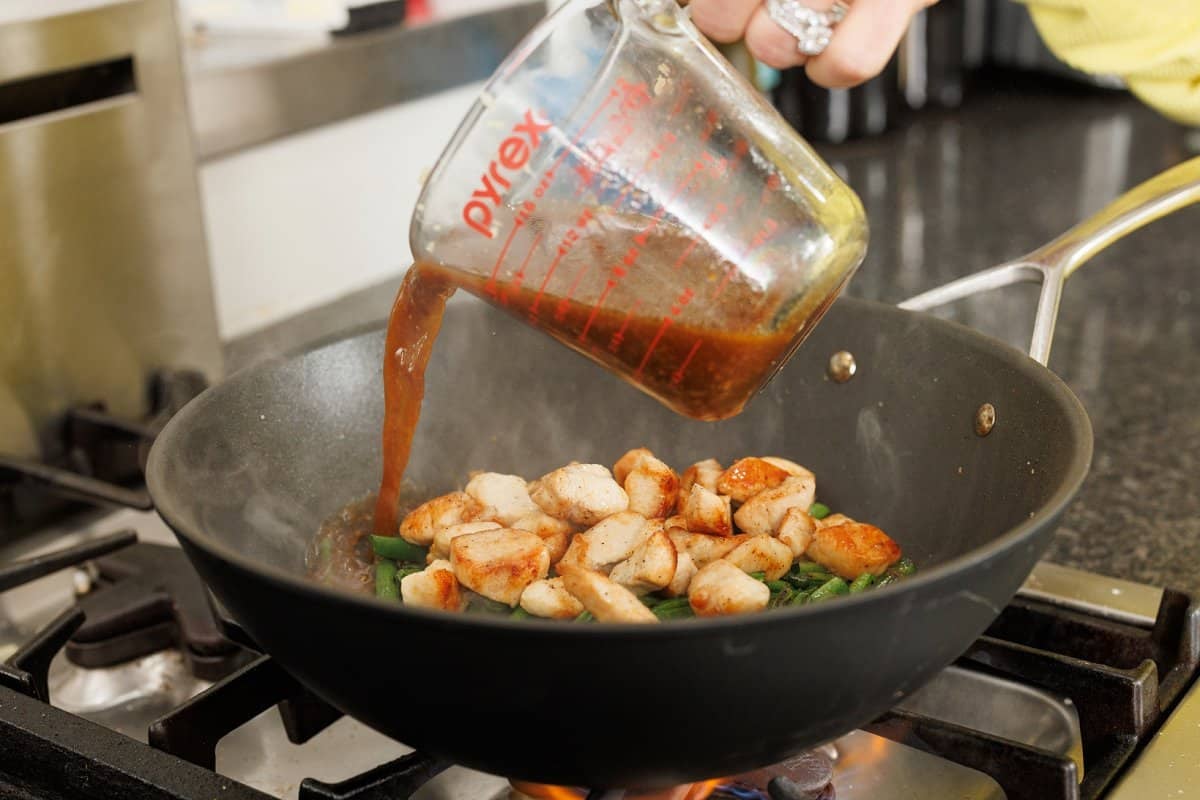 Adding sauce to stir fry