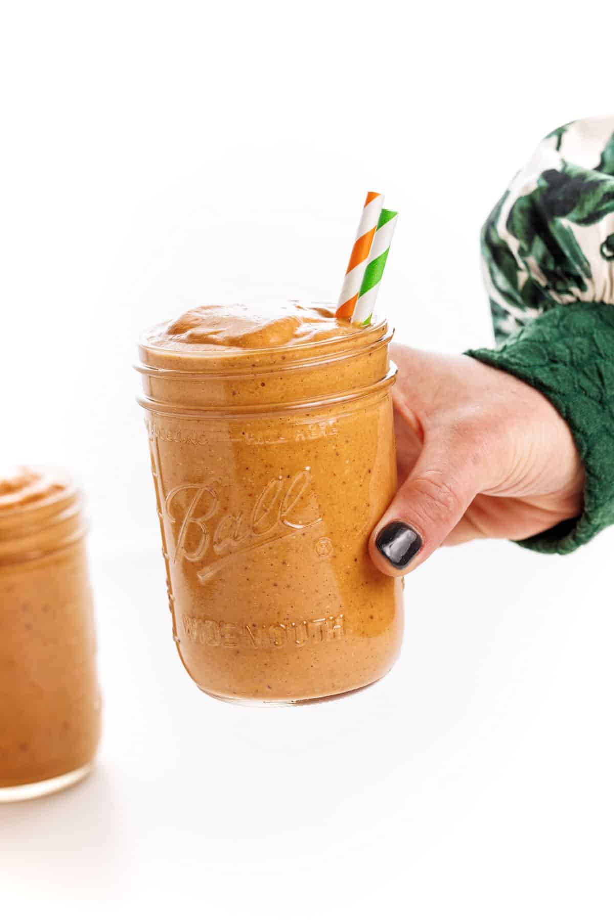 Holding a pumpkin pie protein smoothie.