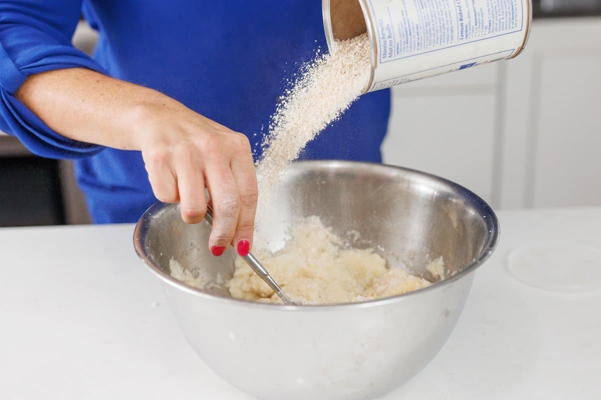 Adding matzo meal to bowl