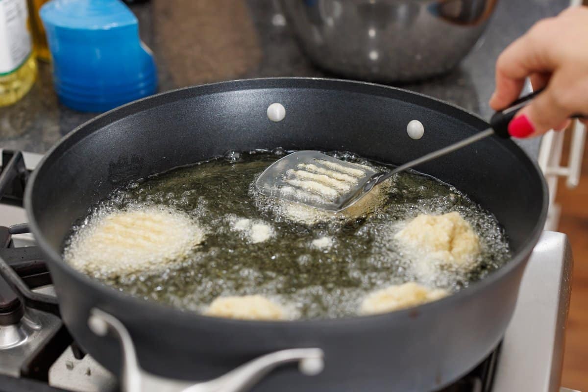 Flattening latkes in oil