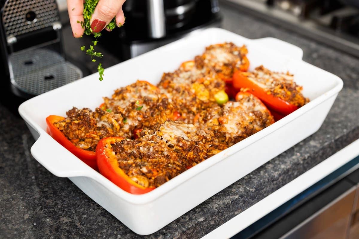 Topping stuffed peppers with herbs