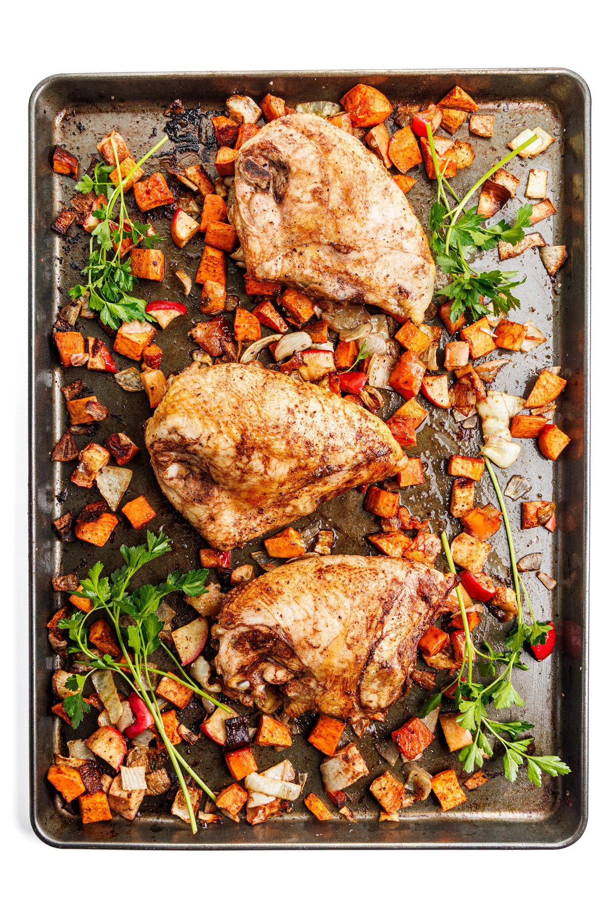Full sheet pan of chicken and sweet potatoes.