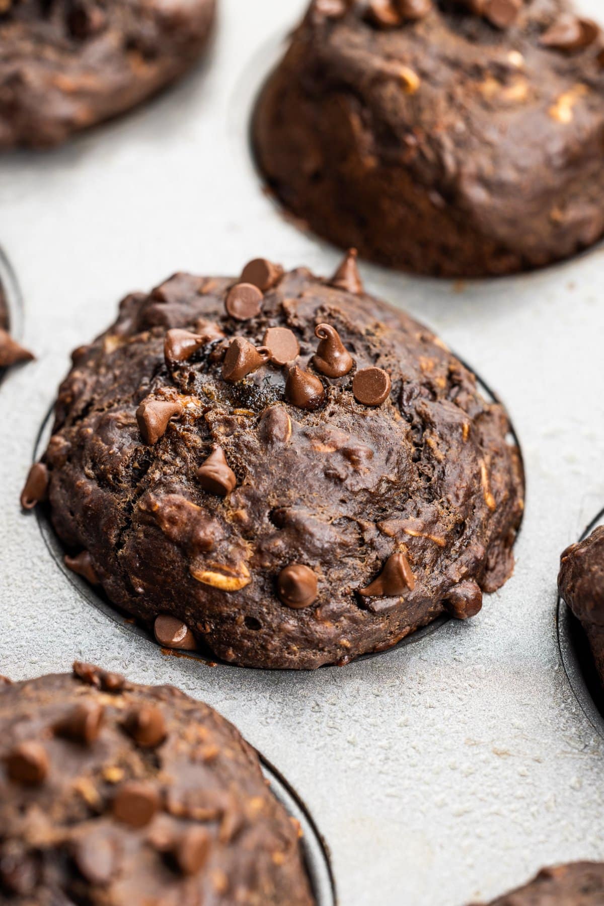 Chocolate banana oat muffins baked in muffin tin.