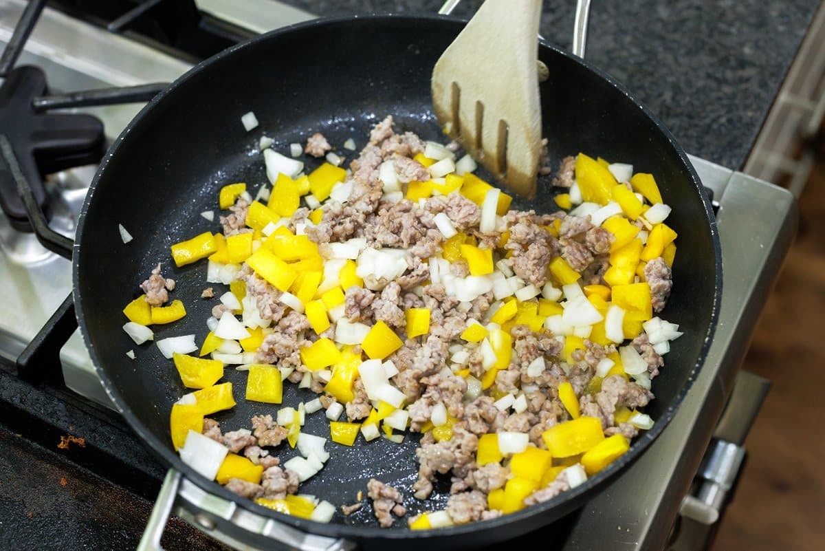 Sautéing onion and pepper with ground sauasge.