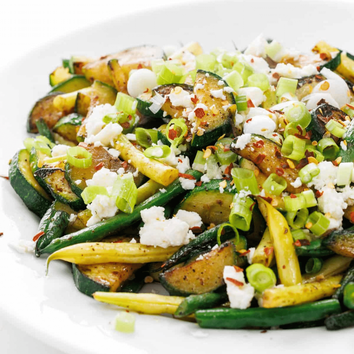 Zucchini and green bean sauté topped with feta and chili flakes.