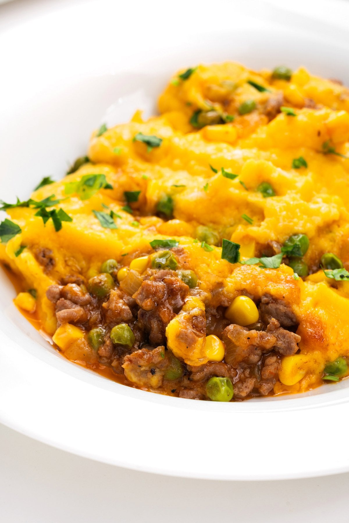 Portion of shepherd's pie with butternut squash in a bowl.