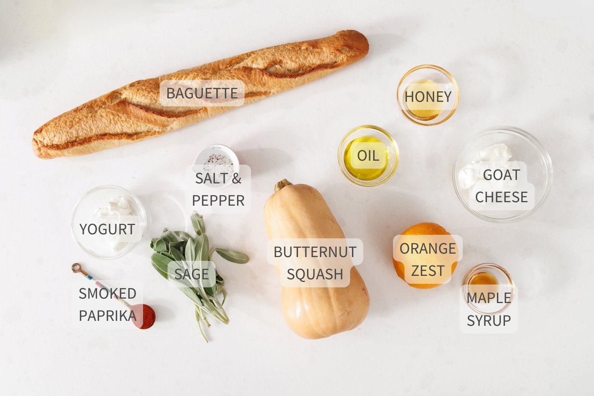 Labeled ingredients for butternut squash crostini on a white counter.