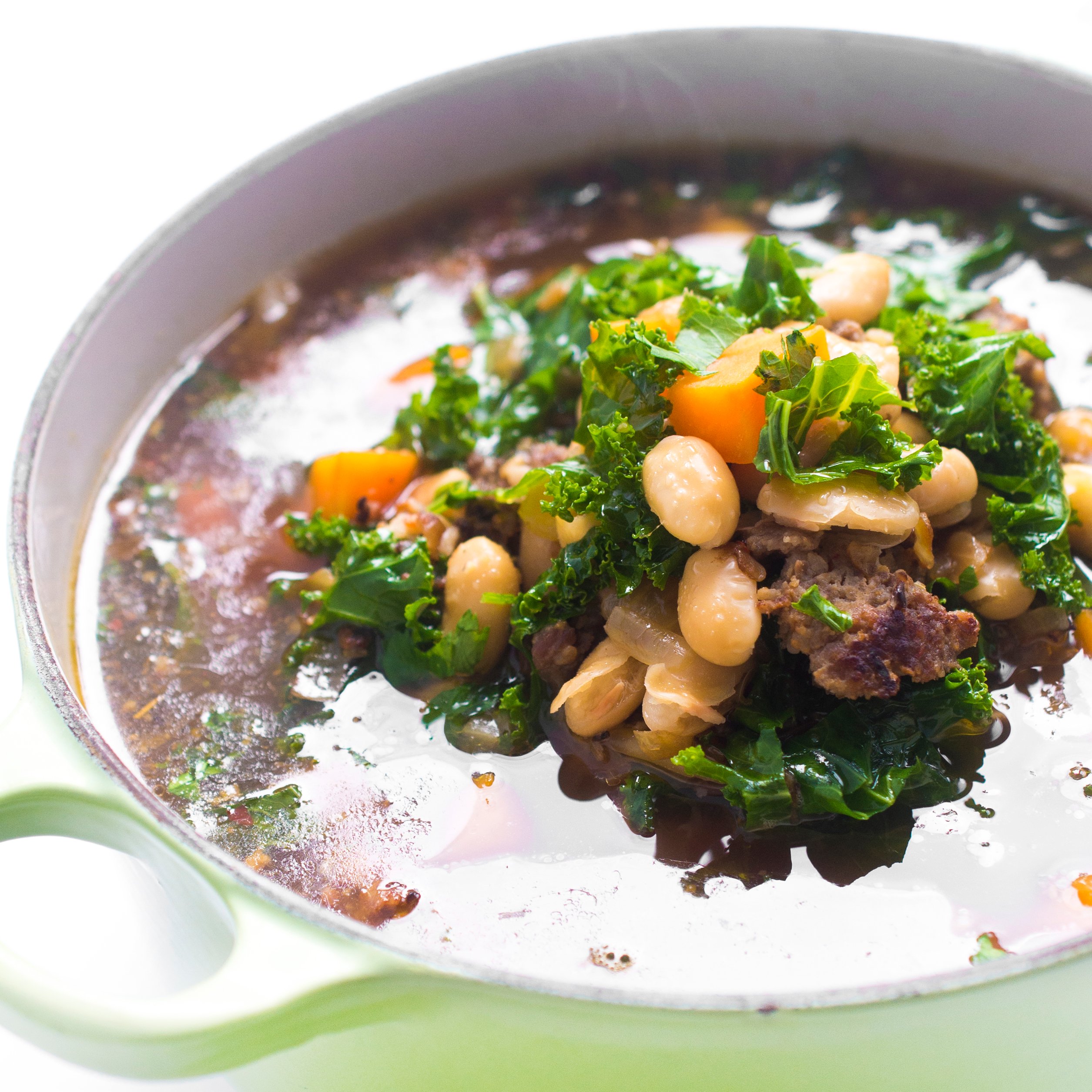 Pot of sausage, bean, and sweet potato soup still steaming.