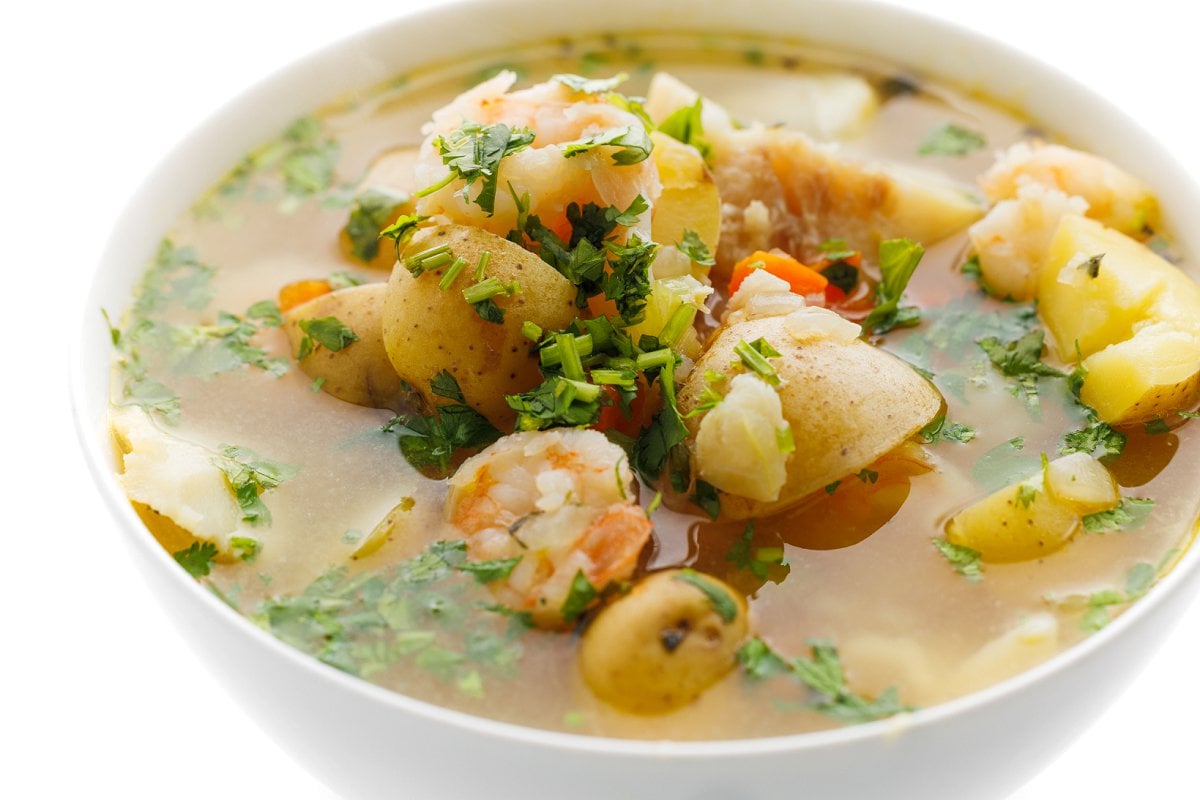 Fish tea in a white bowl, topped with fresh cilantro.