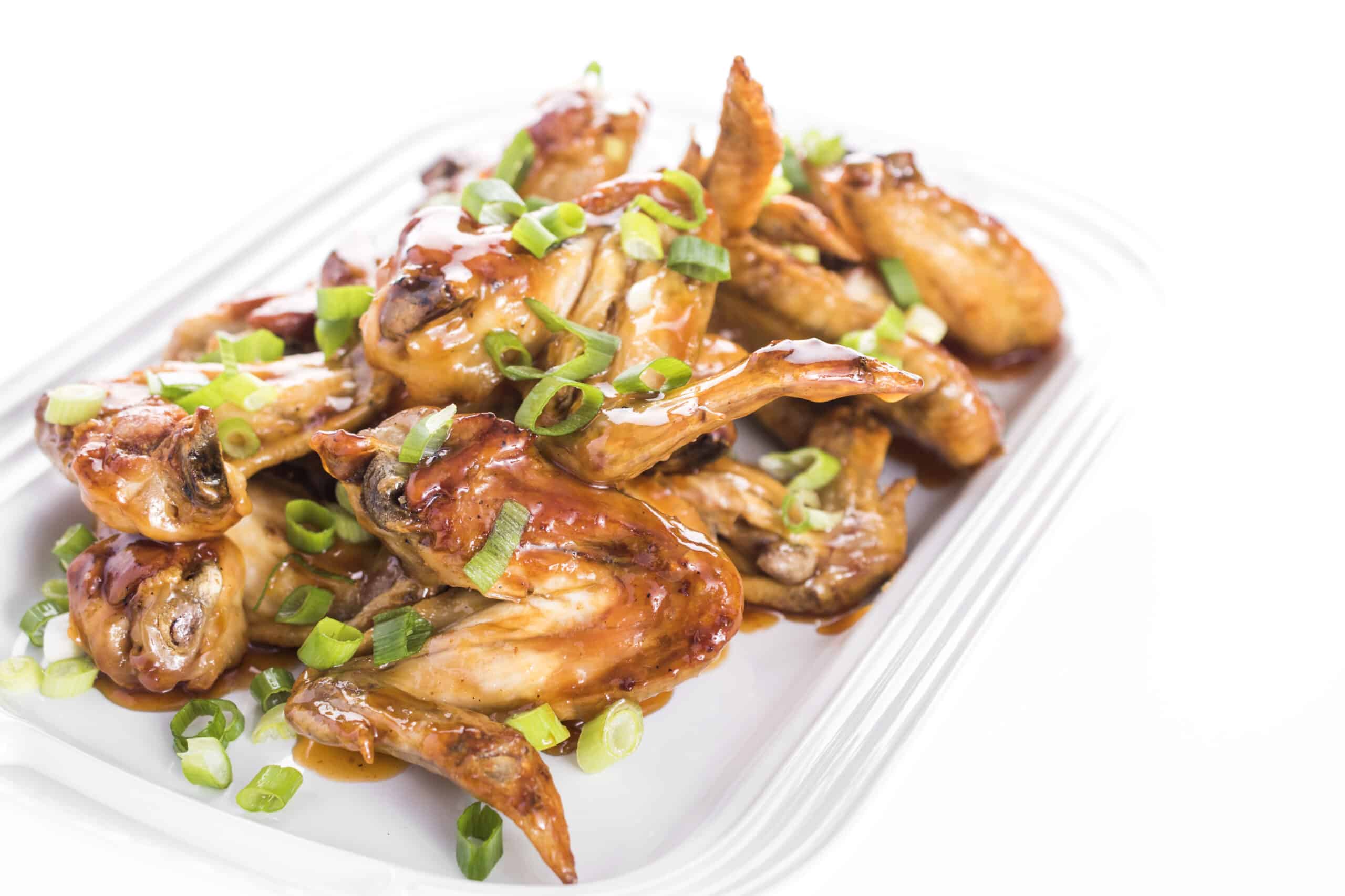 Platter of sauced up, oven baked chicken wings.