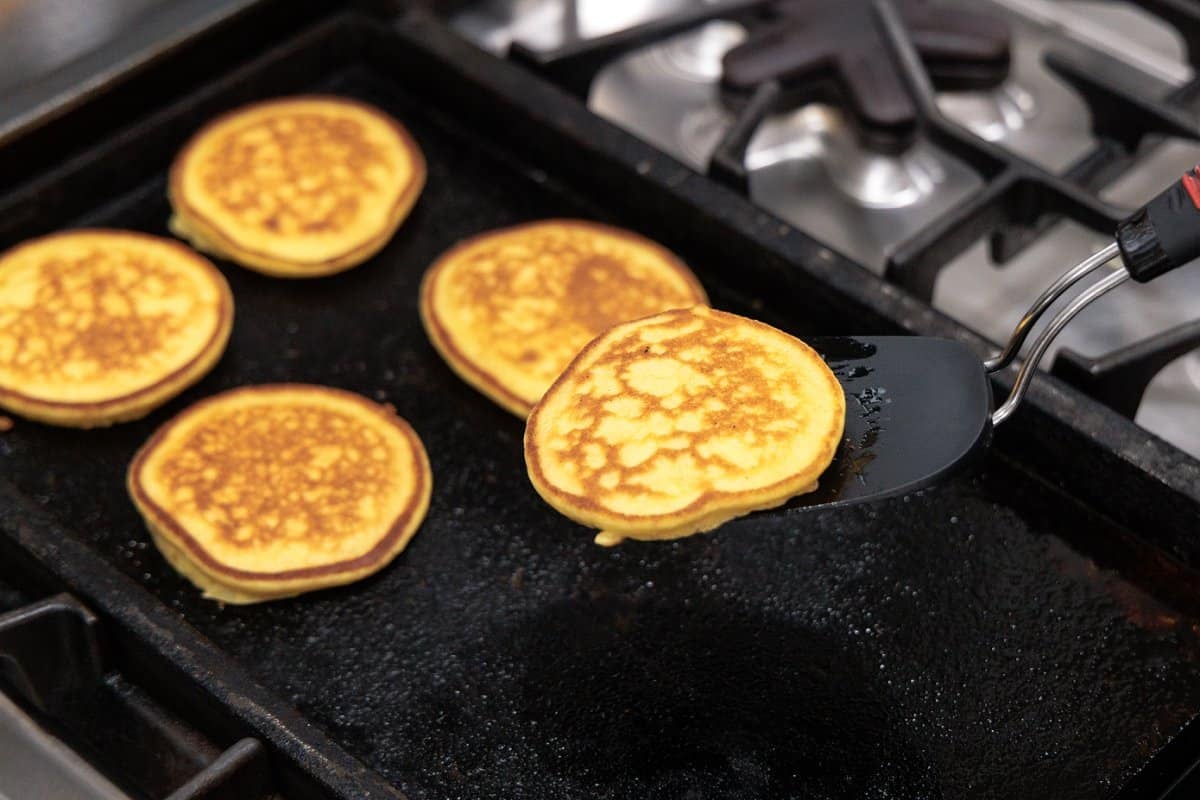 Using a spatula to flip pancakes.