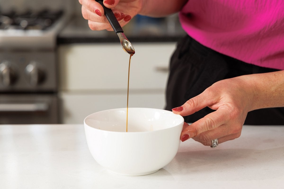 Adding vanilla to bowl.
