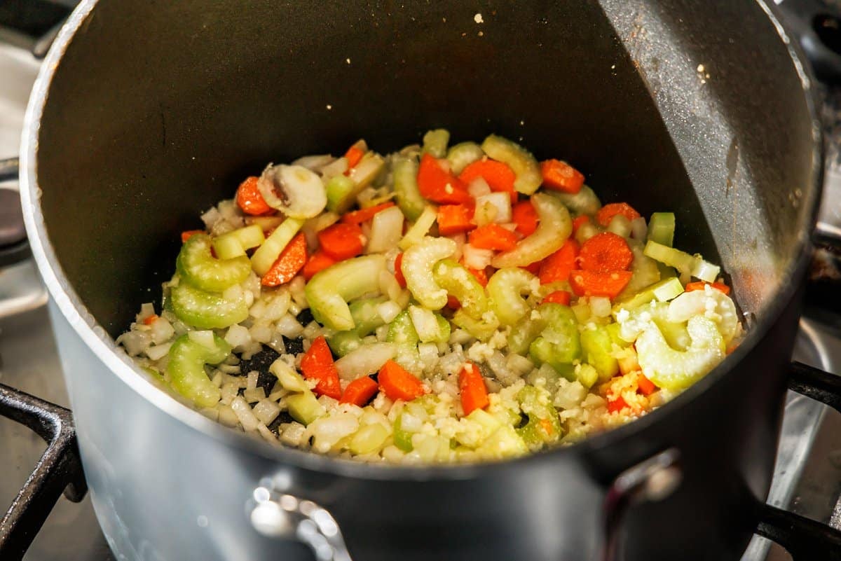 Cooking mirepoix in the bottom of soup pot.