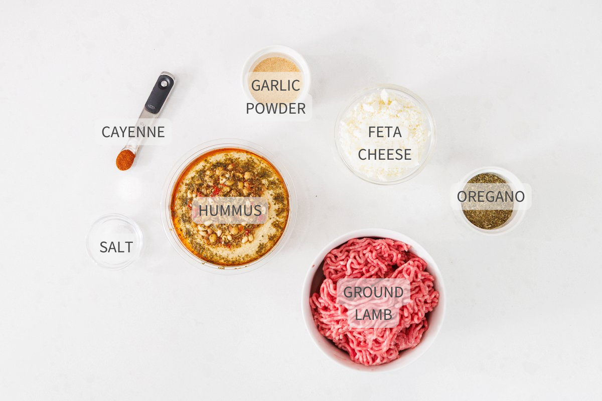 Labeled ingredients for Greek baked hummus dip on a white counter.