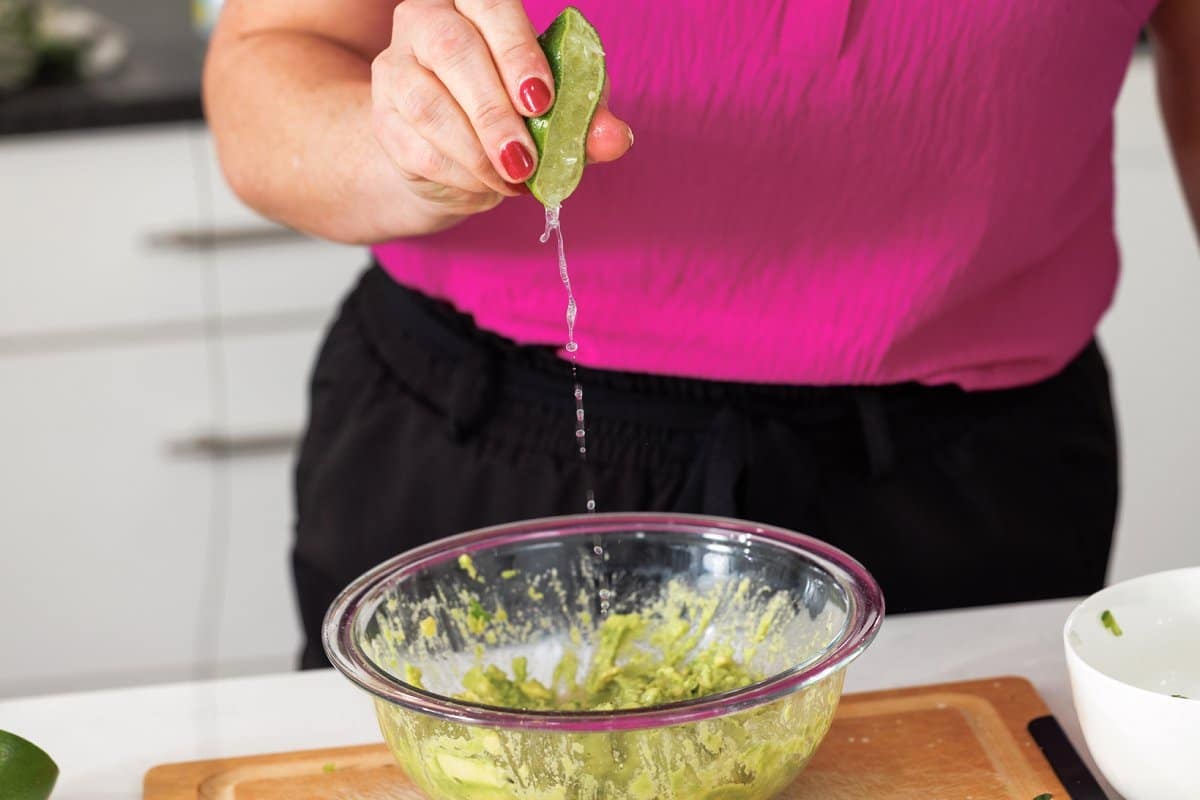 Juicing lime into guacamole.