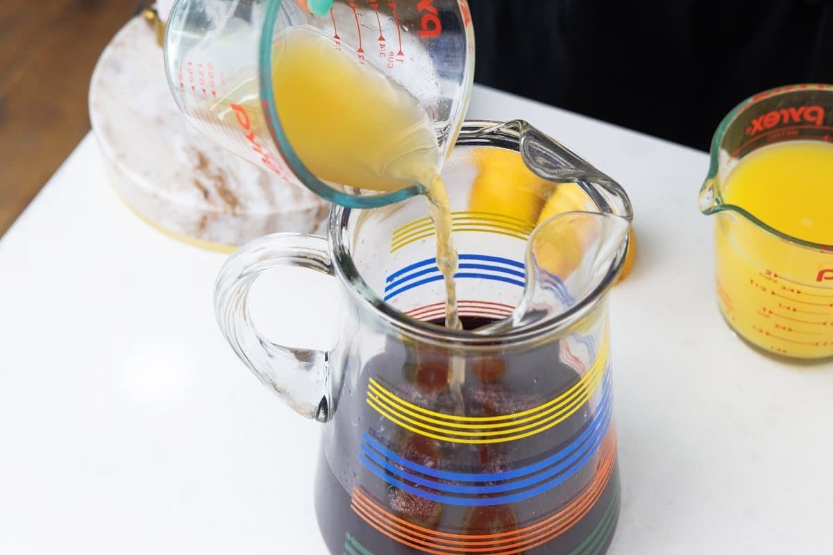 Pouring brandy into pitcher.