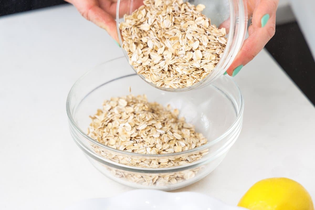 Oats being added to a bowl.