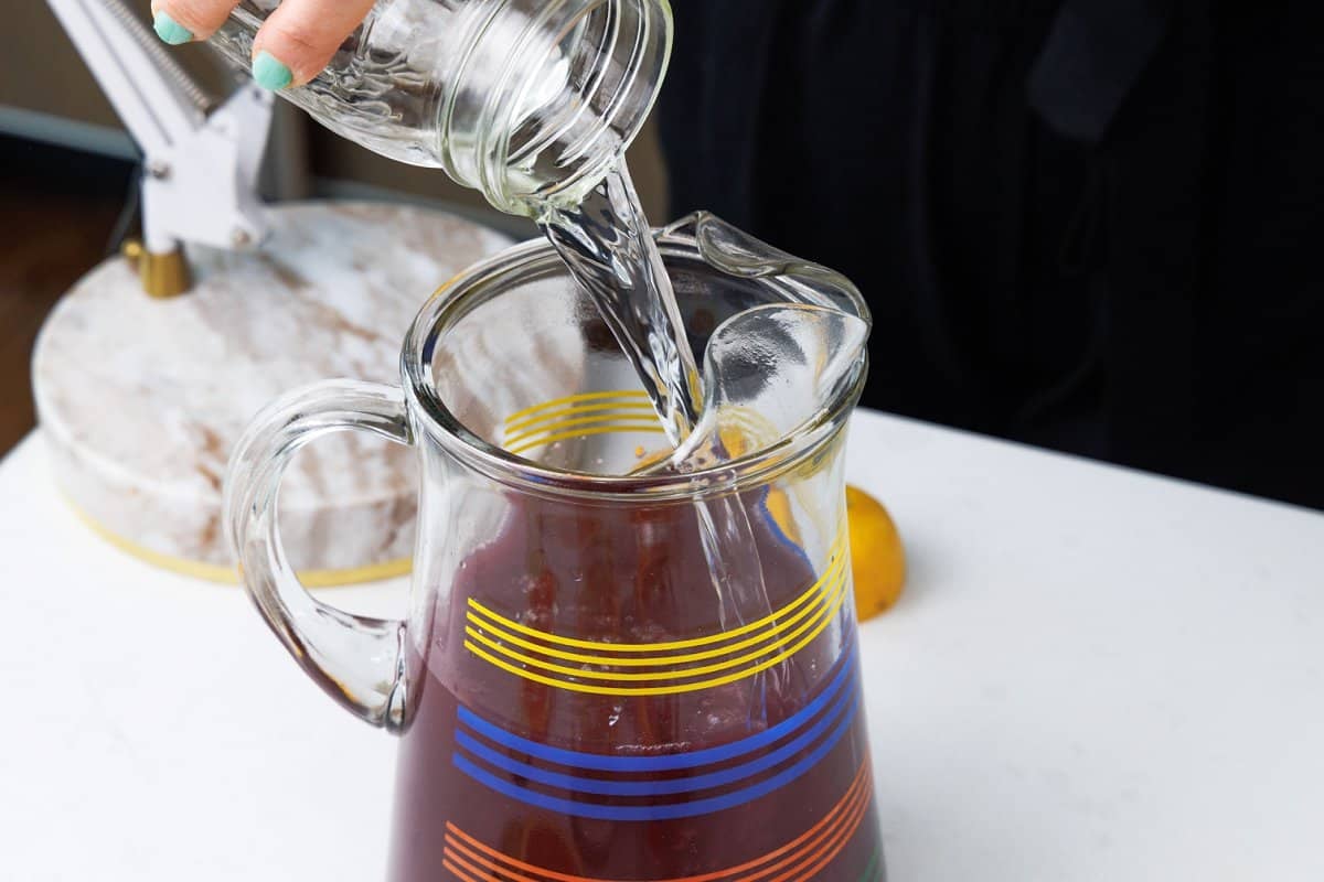 Pouring triple sec into pitcher.