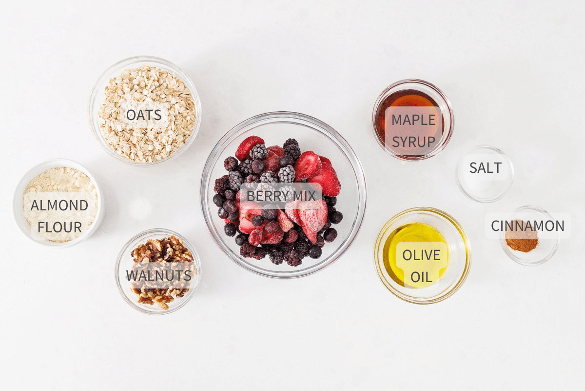 Labeled ingredients for triple berry crisp on a white counter.