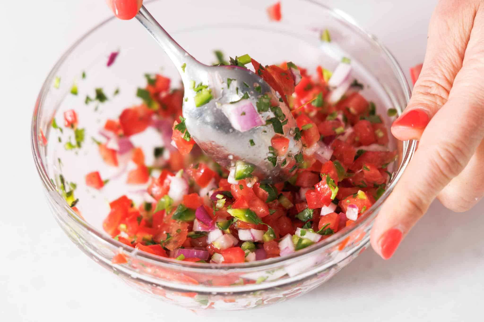 Stirring pico de gallo.