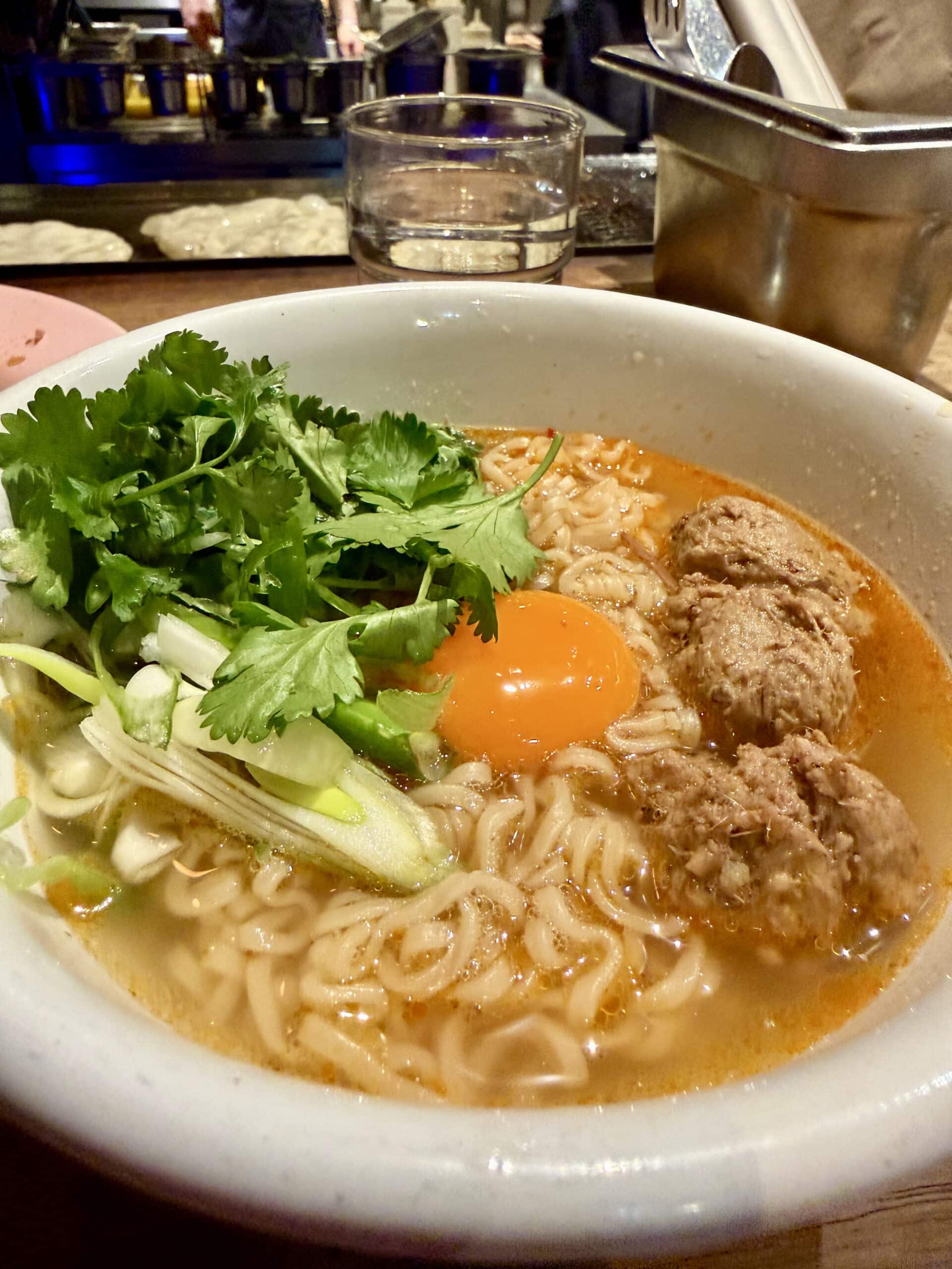Thai food from the Smoking Goat, noodles with fresh egg yolk and greens.