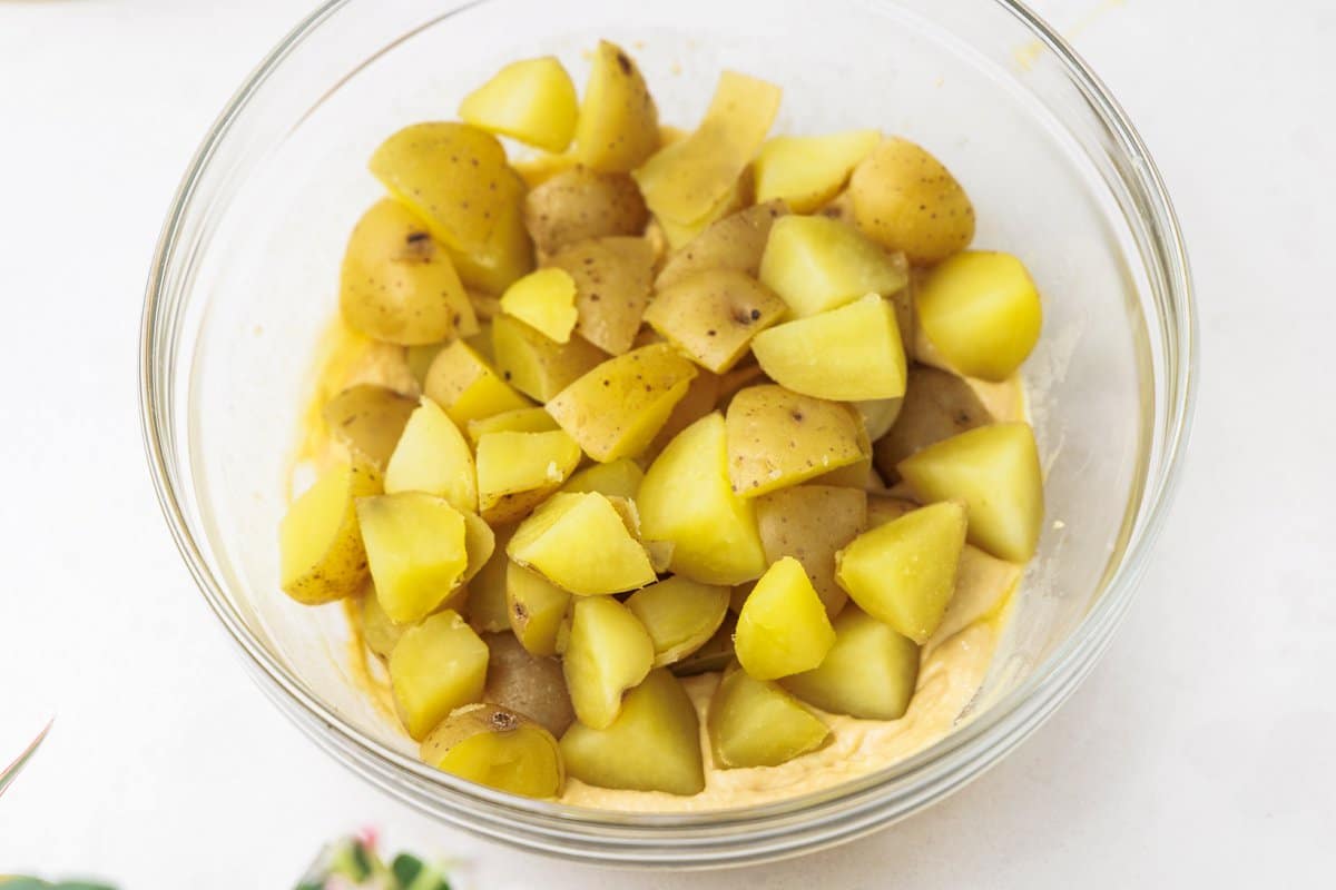 Cooked potatoes in a large glass bowl.