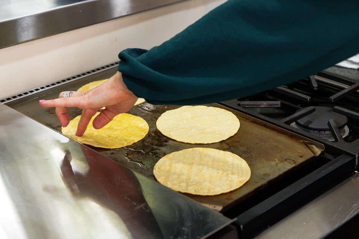 Warming tortillas on a griddle.