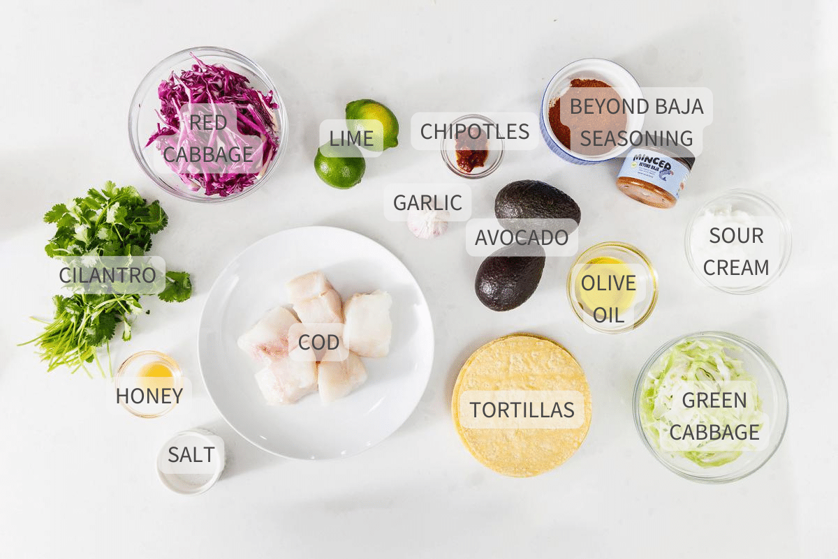 Labeled ingredients for grilled baja fish tacos on a white counter.