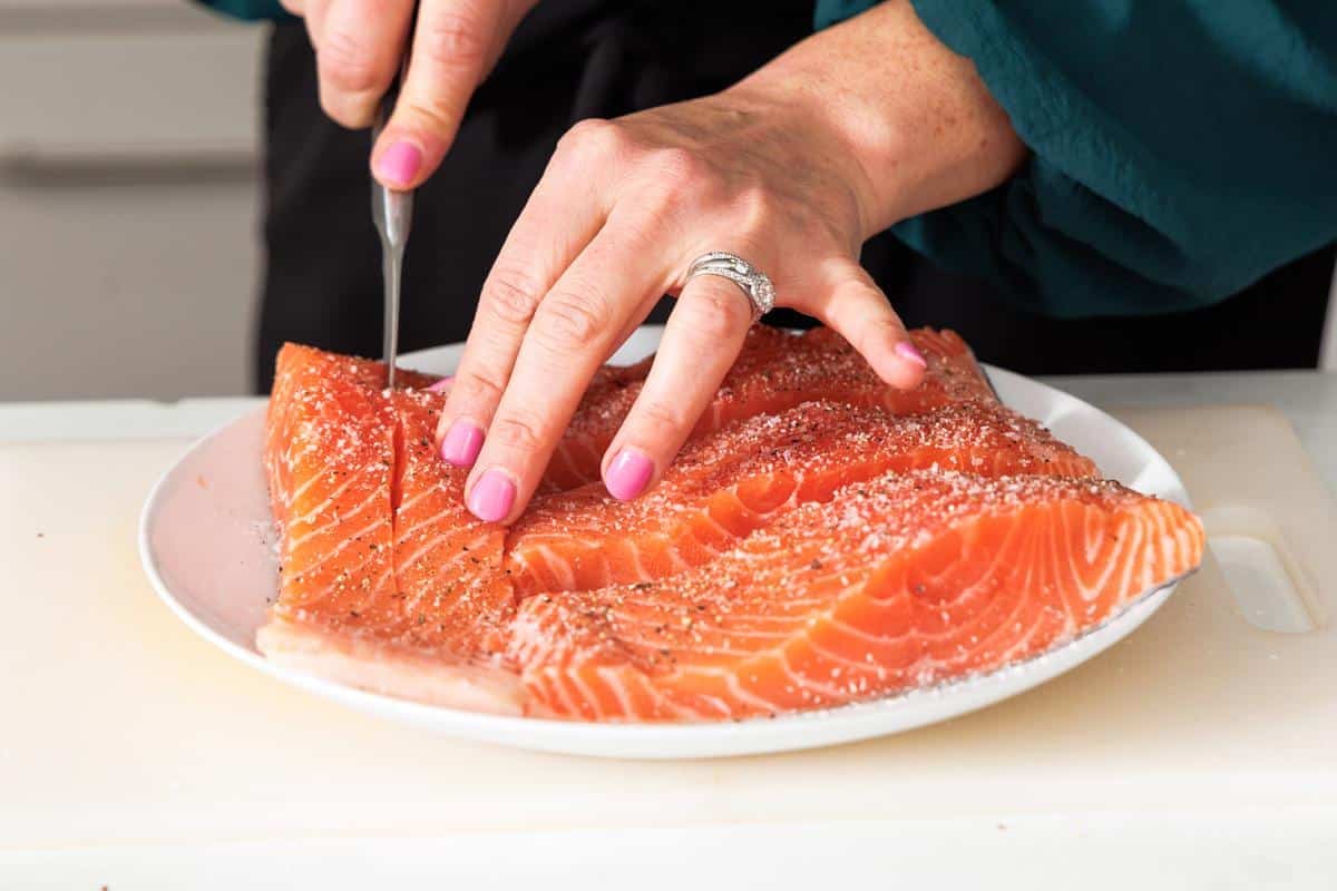 Cutting opening in center of salmon fillets to stuff.