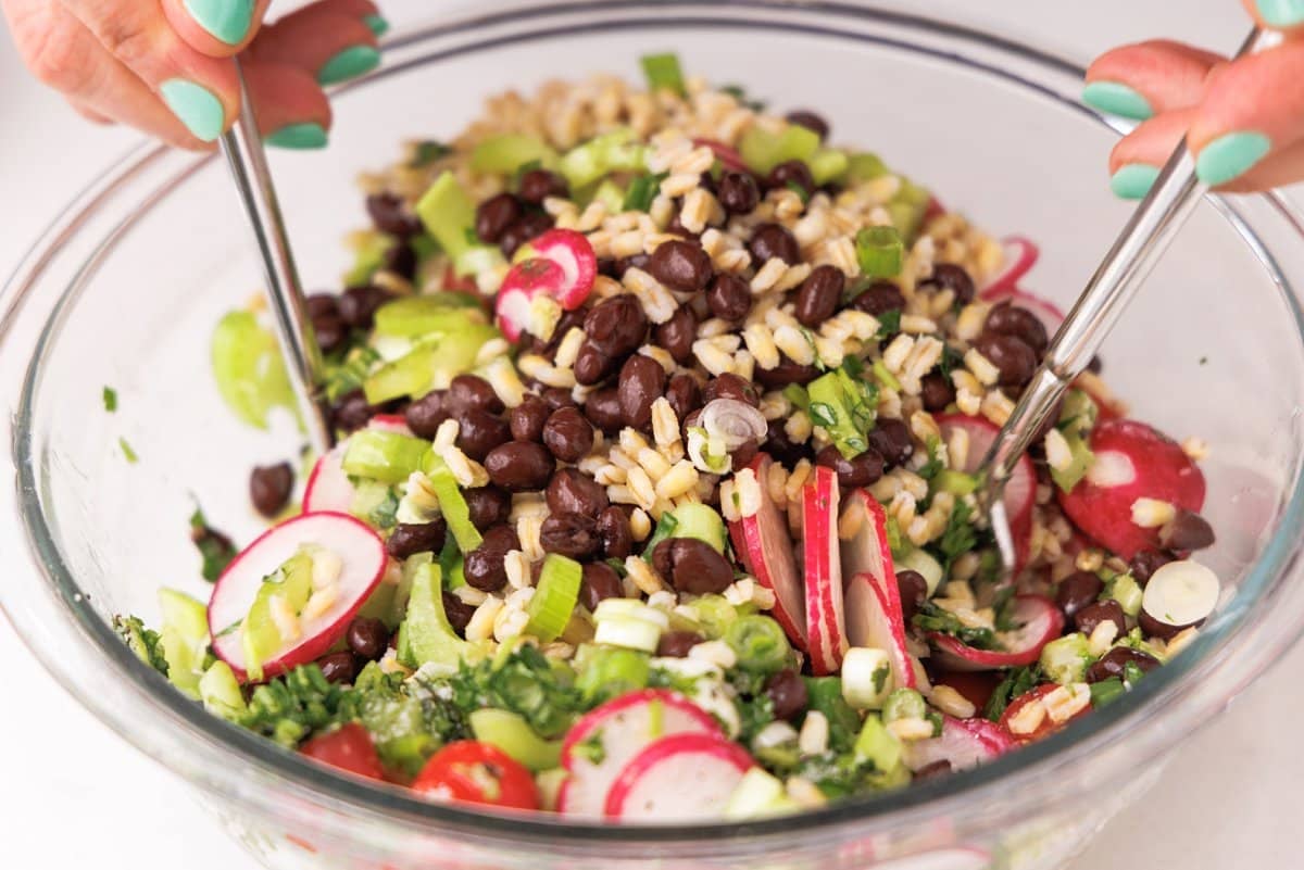 Tossing salad in vinaigrette.