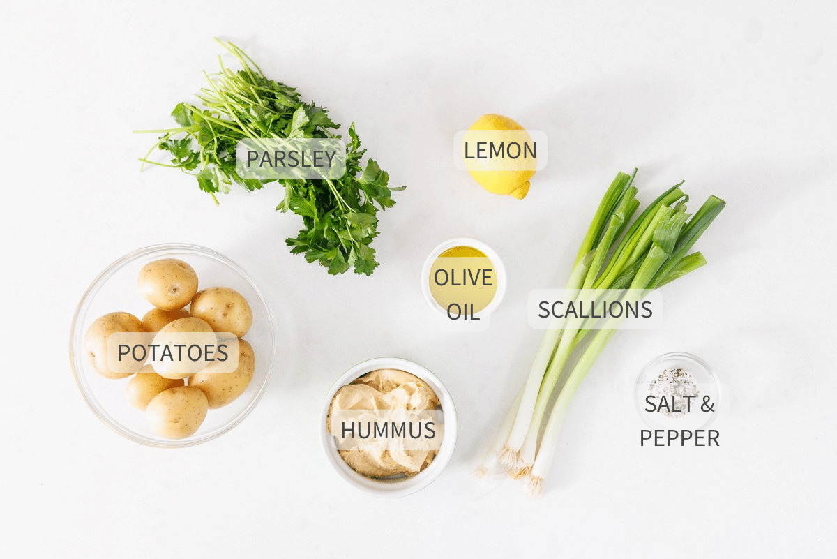 Labeled ingredients for vegan potato salad on a counter.