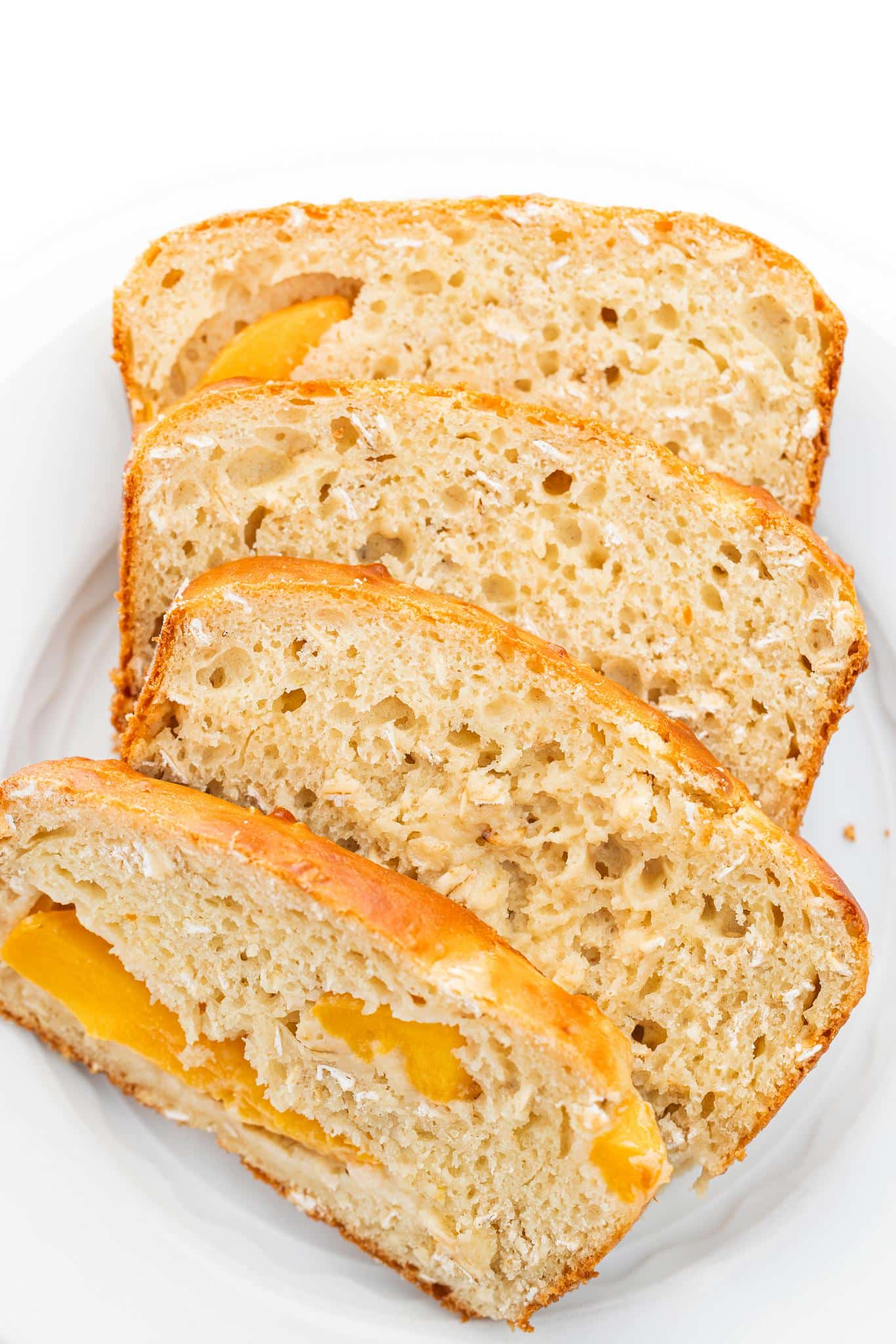 Slices of gluten-free peach oatmeal bread on a plate.