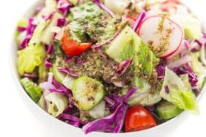 Lebanese salad with lemon garlic dressing in a white bowl