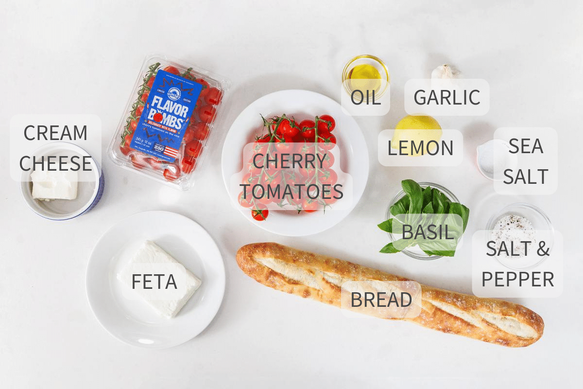 Labeled ingredients for cherry tomato bruschetta on a counter.