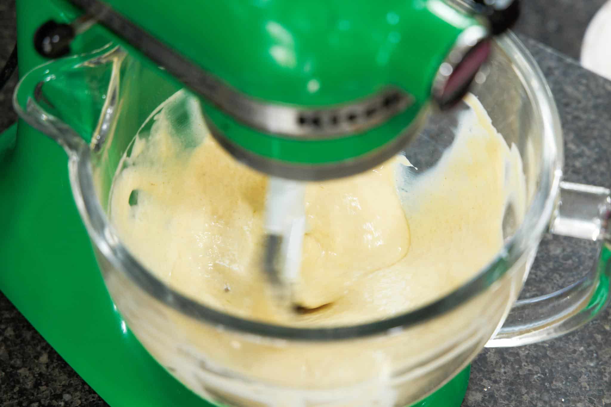 Mixing wet ingredients in the bowl of a stand mixer.