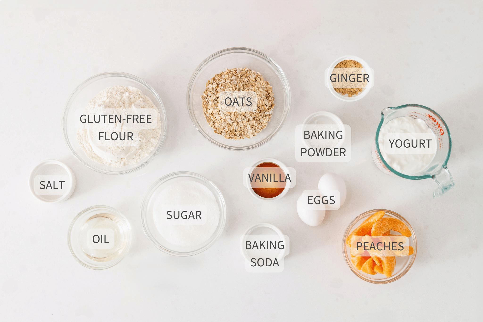 Labeled ingredients for peach oatmeal bread on a white counter.