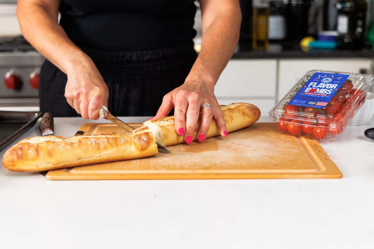 Cutting Italian bread loaf in half.