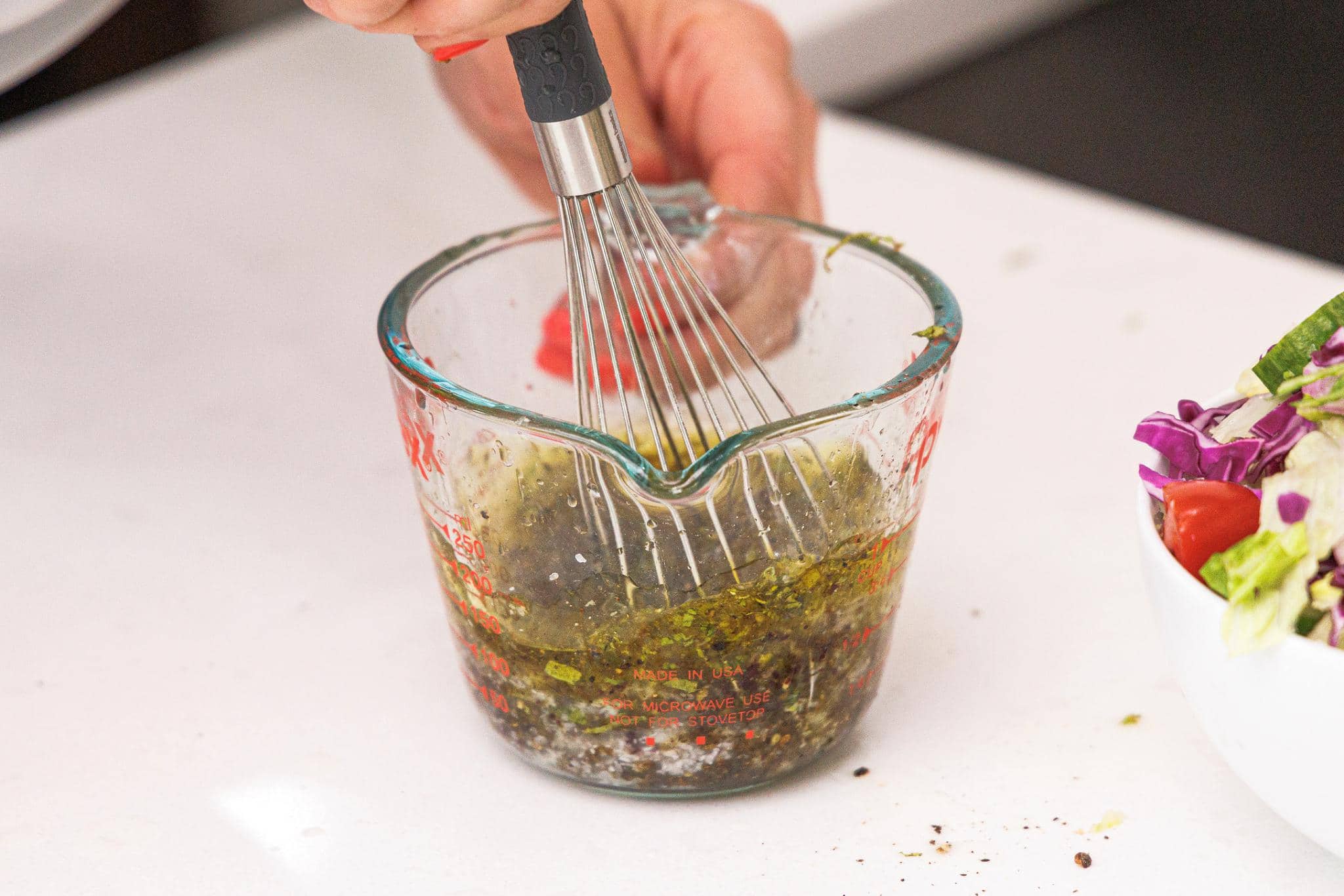 Whisking together Lebanese salad dressing.